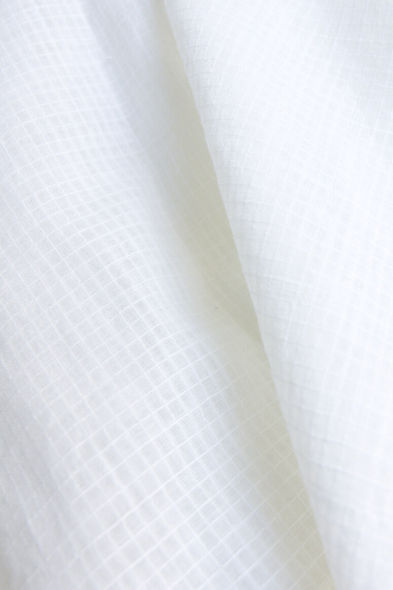 Taylor Tall close up of cream fabric for drop shoulder button up top for tall women.
